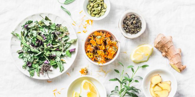 cleansing herbs, greens, and lemon for a detoxifying tea